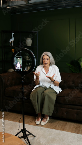 Senior woman creating content, talking on camera for a video blog