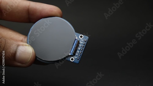 TFT LCD display module of round type held in the hand showing the details of the screen