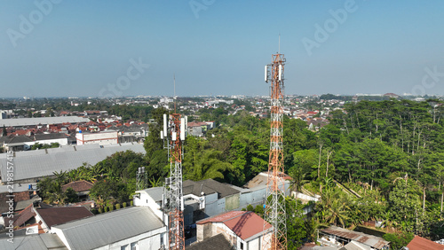 Aerial urban view featuring telecom tower above Yogyakarta buildings and greenery