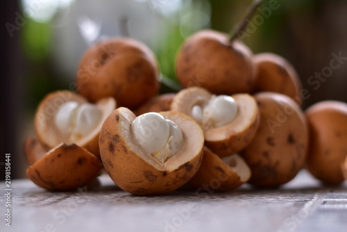 fruit is called greater tampoi aka aglaia sp with white fruit content and light brown fruit skin, Baccaurea macrocarpa fruit