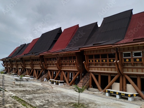  traditional house that appears to be inspired by the shape of a boat or a stilt house with a curved saddle roof, such as the Omo Hada traditional house from Nias