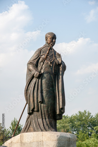 XI'AN, CHINA - JUNE 12, 2009: Bronze statue of the Buddhist monk Xuanzang in front of Da Ci'en Temple near the Giant Wild Goose Pagoda in Xi'an, Shaanxi, China. the Tang Dynasty.