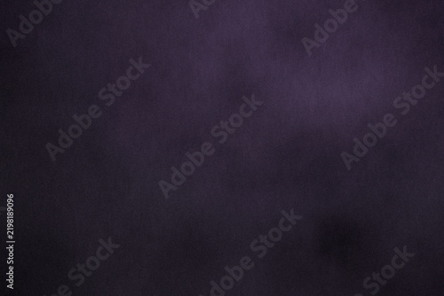 Dark slate-violet grain texture with subtle gradient, matte surface, soft vignette, film noise, abstract backdrop and generous copy space