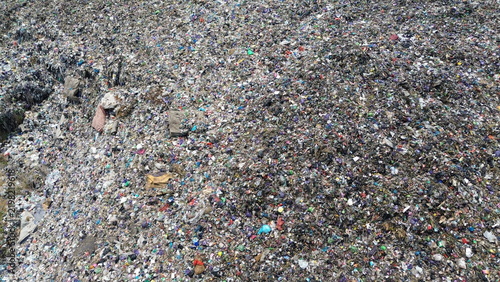 Fotografie Massive Landfill Covered with Plastic and Mixed Waste