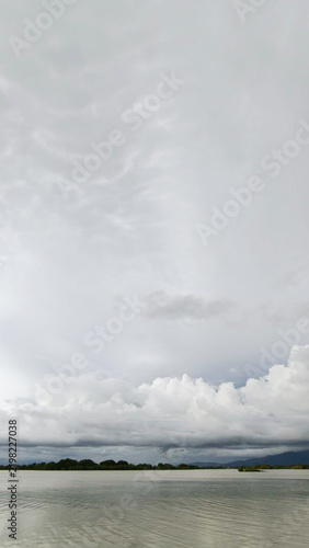Dramatic Cloudy Sky Over Calm Lake Water Landscape
