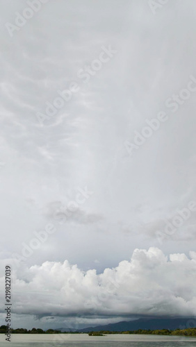 Dramatic Cloudy Sky Over Calm Lake Water Landscape