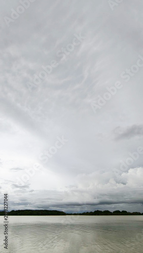 Dramatic Cloudy Sky Over Calm Lake Water Landscape