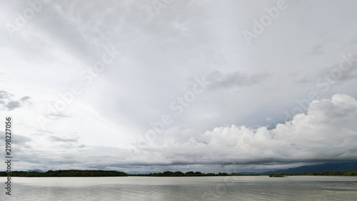 Dramatic Cloudy Sky Over Calm Lake Water Landscape