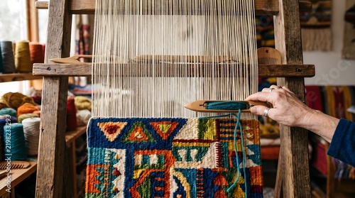 Traditional wooden loom weaving colorful tapestry, artisan hand using shuttle on textile loom, rustic workshop with wool yarn spools