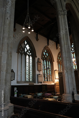 Church interior with cafe seating below stained glass Newark