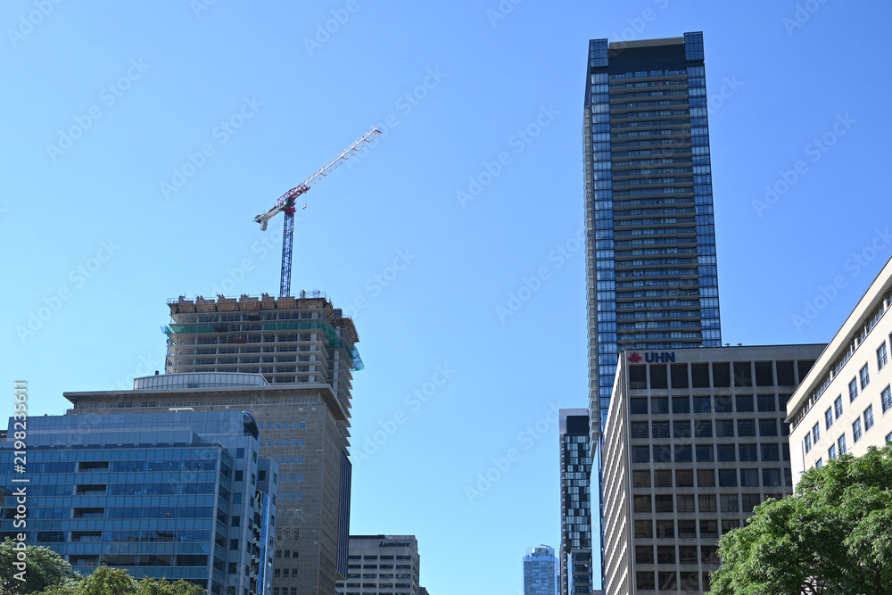 Obraz premium Toronto, Ontario, Canada - June 28, 2026: Construction crane and skyscrapers in Toronto.