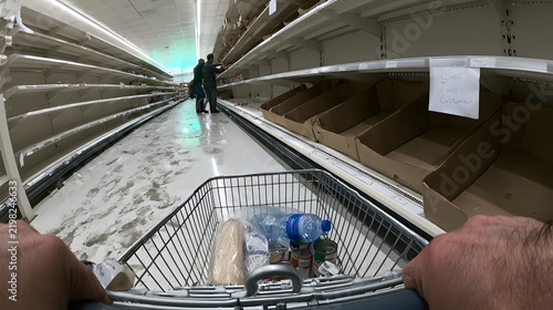 POV Pushing Trolley Past Empty Shelves Before Winter Storm.