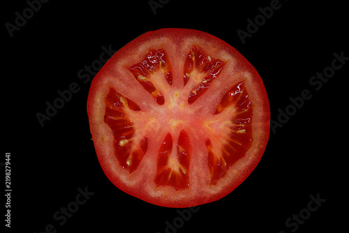 Фотография Sliced Half Tomato Cross Section Backlit on Black Background – Fresh Red Vegetab