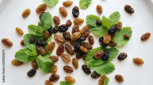 Fresh mint leaves with brown and black dried raisins illustration