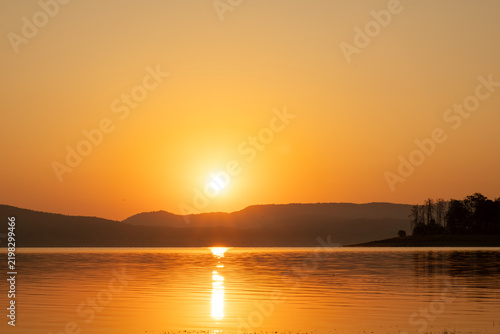 Serene Lake Panorama Sunrise Golden Hour Bright Sun Disk Mountain Ridge Silhouette Peaceful Water Reflection Batak Reservoir Bulgaria Nature