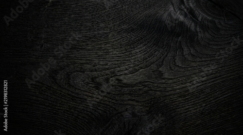 Rich dark bog oak charcoal wood texture background with intricate natural grain patterns and deep, elegant tones.