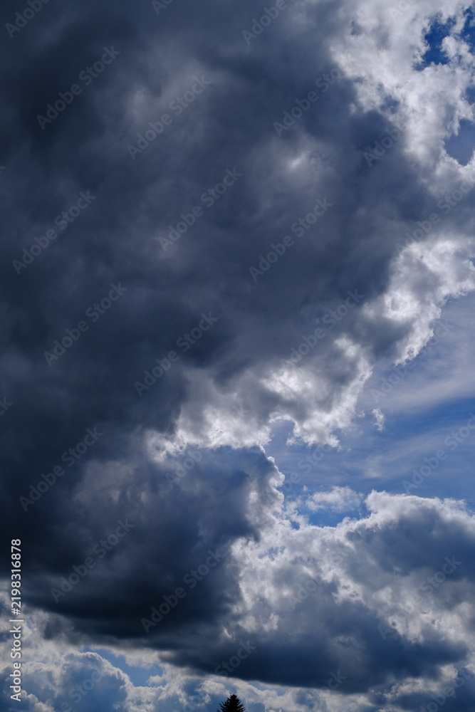 Obraz premium Dramatic Storm Clouds with Bright Edges and Blue Sky