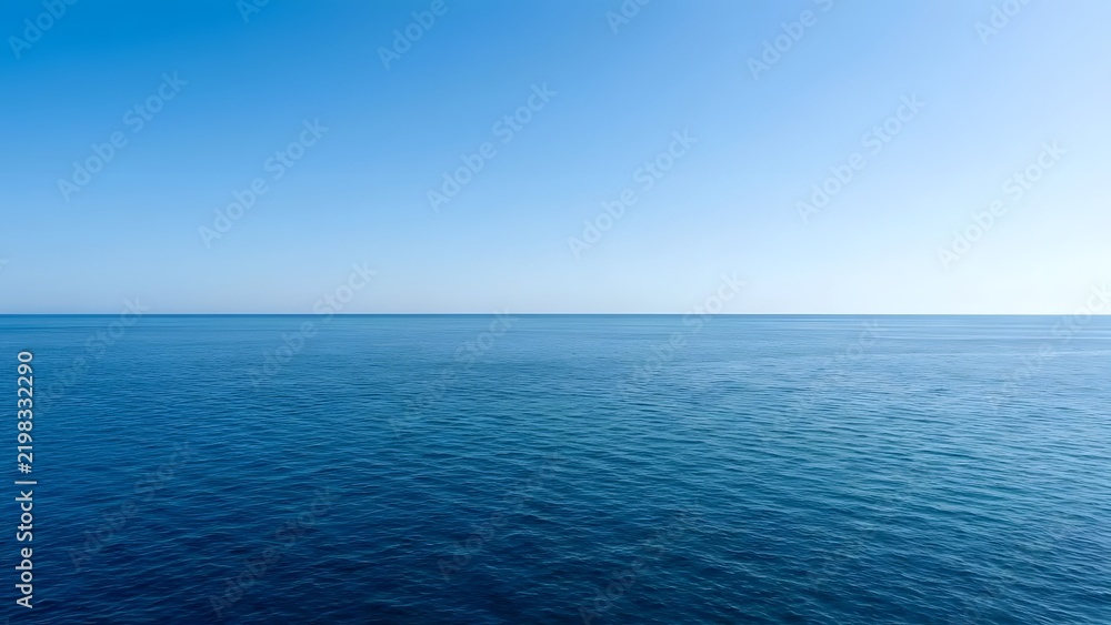 Obraz premium An unobstructed view of deep blue ocean waters meeting a bright cloudless sky at the distant horizon line showing subtle wave patterns across the sea
