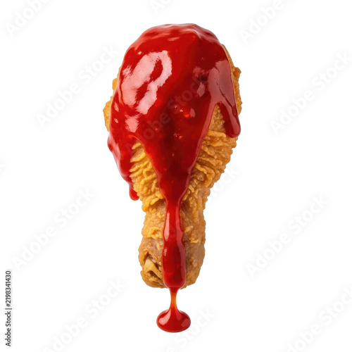 Crispy fried chicken drumstick covered in thick red tomato ketchup sauce