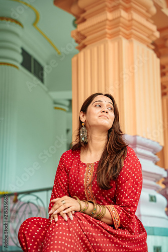 A woman in traditional dress poses for a portrait at Chhatarpur Temple (Shri Adya Katyayani Shakti Peeth Mandir), one of the largest temple complexes in India, in South Delhi.