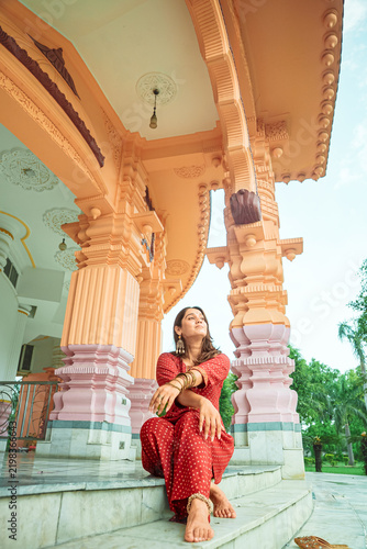 A woman in traditional dress poses for a portrait at Chhatarpur Temple (Shri Adya Katyayani Shakti Peeth Mandir), one of the largest temple complexes in India, in South Delhi.