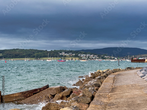 Coastal Sea Wall and Sandy Beach Under Stormy Clouds at Exmouth, Devon
