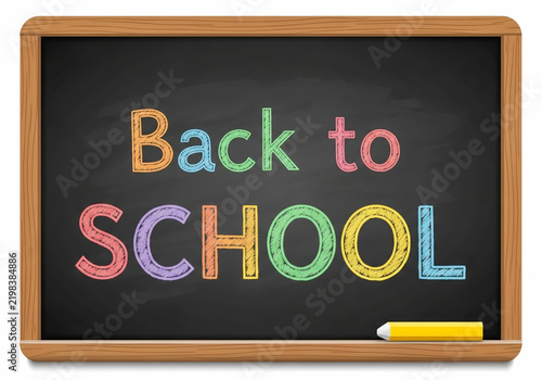 Back to school text written on a wooden chalkboard