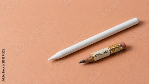 Conceptual image of skill gap with pencil and digital pen