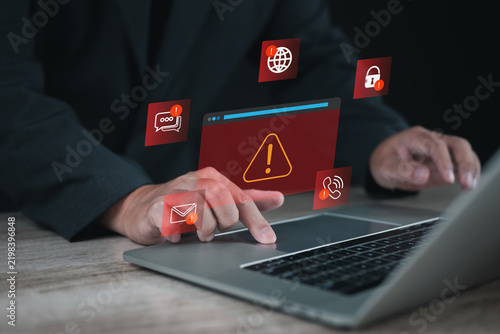 Cybersecurity alert on laptop with warning symbols for email, messaging, web, phone and account access, representing digital threats, online risk, data protection, fraud prevention and security.