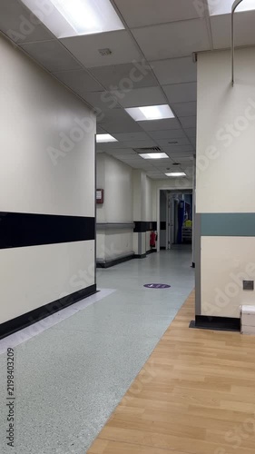Vertical video. Distant shot of Radiology staff in hospital corridor ready for procedure.