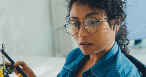 Close-up African American female robotics engineer discussing mechanical part on video call in laboratory. Remote work, virtual training, online meeting, future technology, technical support concept.