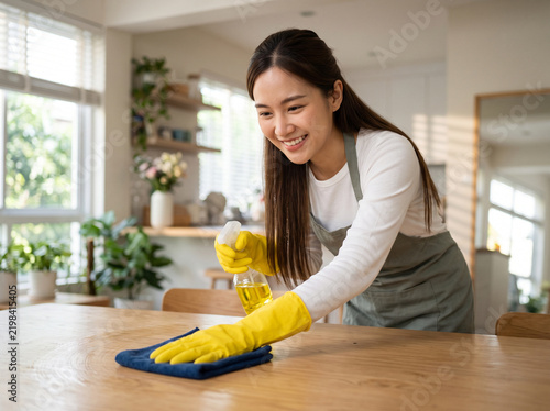 woman cleaning, Asian woman, young woman, kitchen cleaning, cleaning table, wiping table, wooden table, table cleaning, cleaning surface, surface cleaning, microfiber cloth, cleaning cloth, spray clea