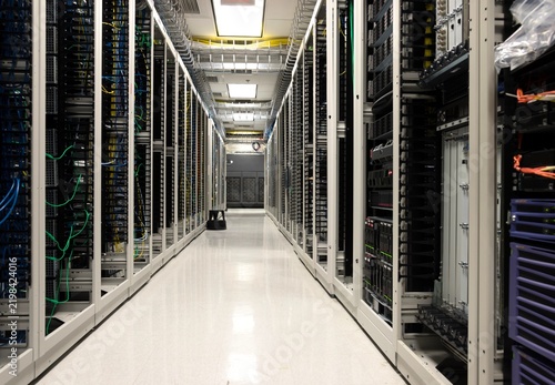 Фотография Modern Data Center Server Room with Network Racks, Fiber Optic Cables and High P