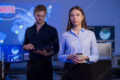 Cybersecurity professionals working collaboratively in a high-tech control room
