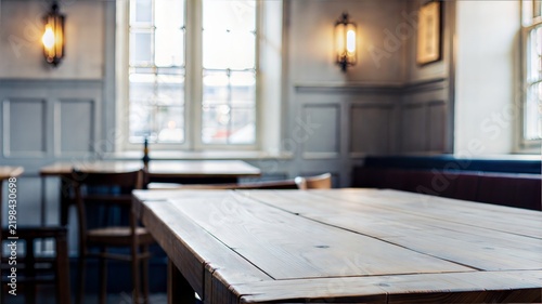 A close-up shot of a rustic wooden tabletop in a cozy restaurant or cafe interior. the table surface for food photography mockups, menu designs, or hospitality branding.
