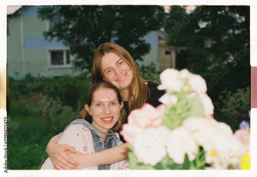 Friends hold each other close as twilight settles in