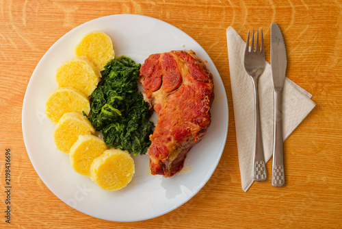 Czech food pork meat with potato dumpling and spinach top view