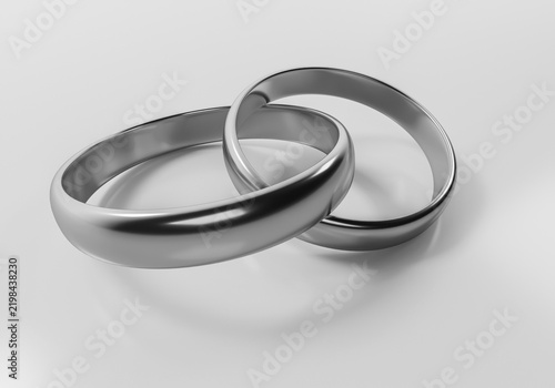 Two silver wedding rings interlinked as a concept of love marriage and eternal union