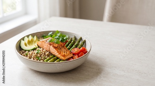 Grilled salmon grain bowl with asparagus and avocado, healthy roasted fish poke bowl, nutritious balanced meal on light stone background