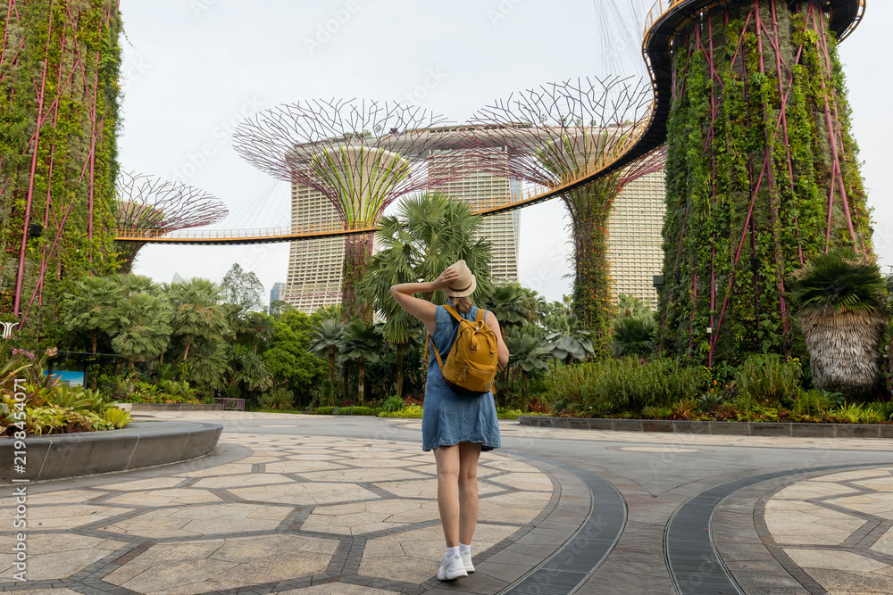 Fototapeta premium Woman traveler wearing blue dress and hat at Gardens by the Bay in Singapore