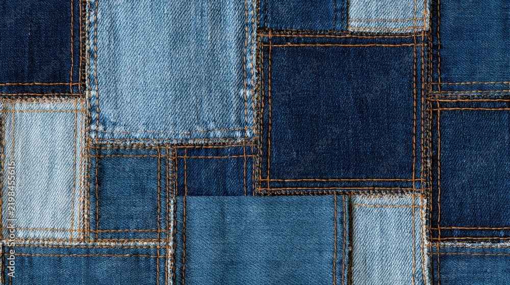 Obraz premium A detailed patchwork of various blue denim fabric squares stitched together. This textured material background is ideal for fashion design and textile industry projects.
