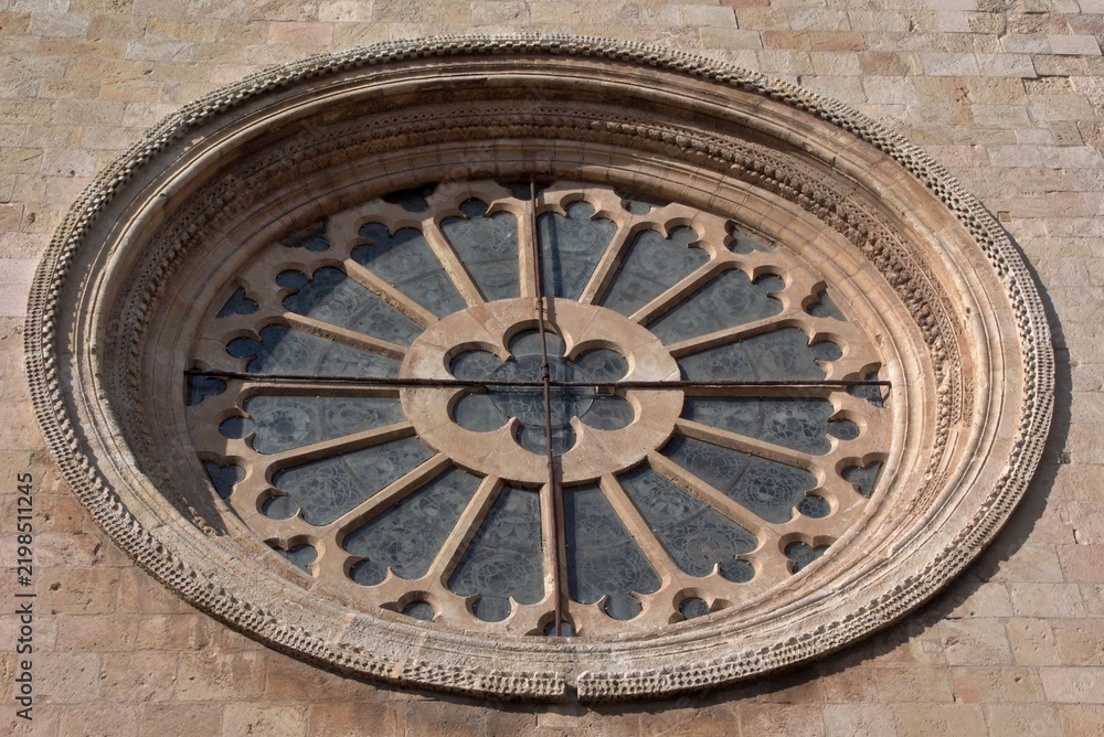 Fototapeta premium Rose window detail on old stone church facade. Tarragona - Spain