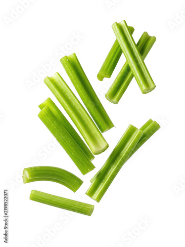 Fresh green celery sticks floating and flying isolated on a transparent background, vibrant raw vegetable pieces arranged in a dynamic falling motion for healthy food and diet concepts in commercial.