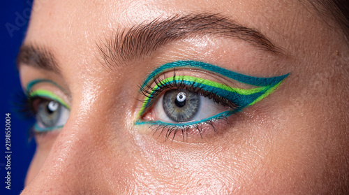 Eyes with colorful eyeliner design and detailed makeup