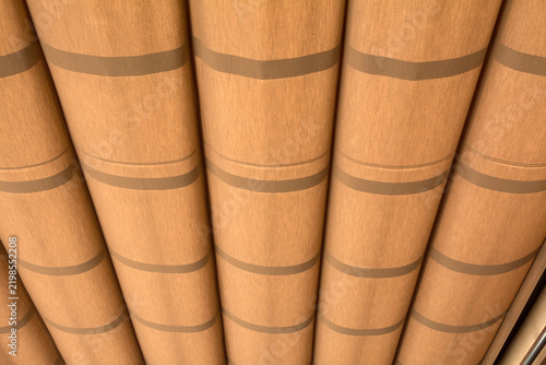 Detail shot of vertical ribbed pillar elements featuring clean lines and a warm earthy color tone.