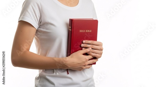 Woman holding holy bible in her hands