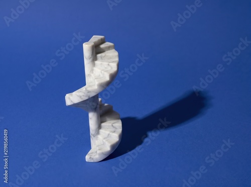 Floating marble spiral staircase casting dramatic shadow