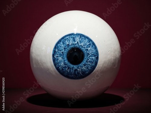 Porcelain eyeball with blue iris floating above surface