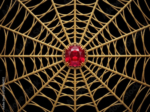 Red ruby centered in ornate gold spiderweb