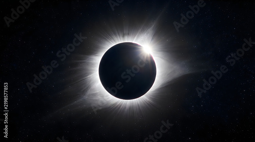 A stunning total solar eclipse with the sun glowing behind the moon in the deep dark space